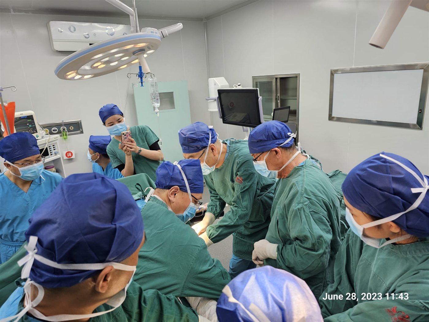 Dr. Topaz performing demonstration surgery with a surgical team in China